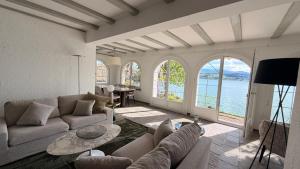 a living room with a couch and a table at Lakefront Villa in Stäfa
