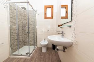 a bathroom with a shower and a sink and a toilet at Giorni Salentini in Torre Lapillo +40 photos