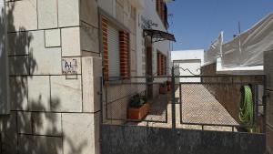 a building with a fence on the side of it at Habita Avenida 9 Abril in Estremoz