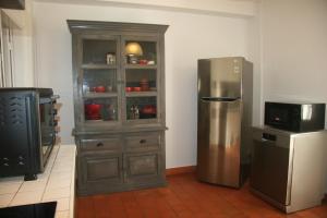 a kitchen with a refrigerator and a hutch at Bleu du Sud in Le Tampon