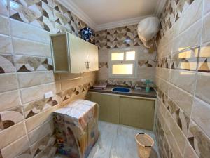 a small kitchen with a sink and a counter at Adamora Stay in Marsa Alam City