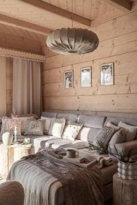 a living room with a large bed and a couch at Ziębowe Ranczo in Chochołów