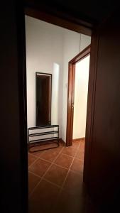 an empty room with a mirror and a tiled floor at Habita Avenida 9 Abril in Estremoz
