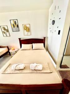 a bedroom with a bed with two towels on it at SMDC Wind Residences Condo Unit by Bil & J's in Kaybagal +13 photos