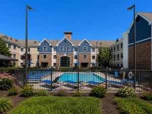 a swimming pool in front of a building at Staybridge Suites Columbia - Baltimore by IHG in Columbia