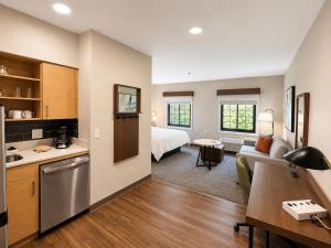 a kitchen and living room with a bed and a couch at Staybridge Suites Columbia - Baltimore by IHG in Columbia