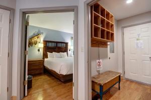 a bedroom with a bed and a door leading into a room at Woods 21 Townhome in Copper Mountain