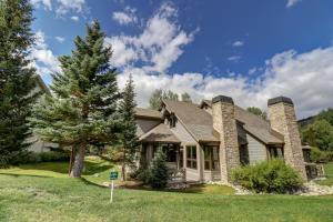 a house with a tree in front of it at Woods 21 Townhome in Copper Mountain
