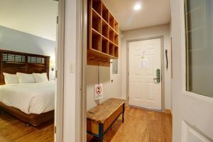 a bedroom with a bed and a wooden bench next to a door at Woods 21 Townhome in Copper Mountain