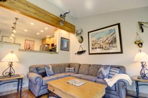 a living room with a couch and a table at Woods 21 Townhome in Copper Mountain +42 photos