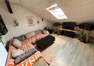 a living room with two couches and a flat screen tv at The Vibe Spot in Podgorica