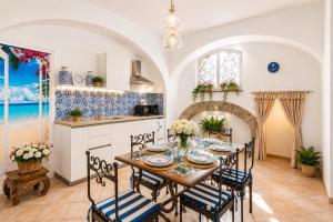 a kitchen and dining room with a table and chairs at Maison Vico94 in Vico Equense