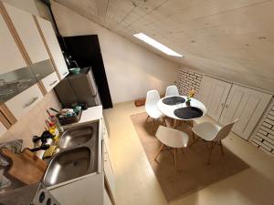an overhead view of a kitchen with a table and chairs at The Vibe Spot in Podgorica
