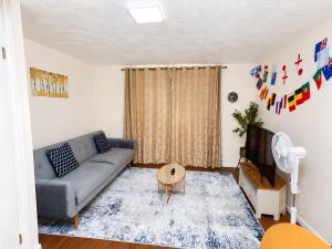 a living room with a couch and a tv at 2- Bed Contractor Home Near Heathrow in Feltham