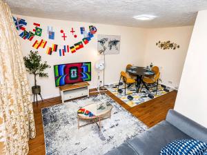 a living room with a couch and a table at 2- Bed Contractor Home Near Heathrow in Feltham