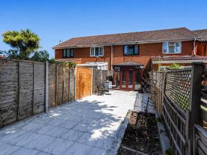 a fence in front of a brick house at 2- Bed Contractor Home Near Heathrow in Feltham