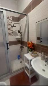 a bathroom with a shower and a sink and a mirror at Premium apartment with balcony in La Gombe in Kinshasa