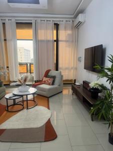 a living room with a couch and a tv at Premium apartment with balcony in La Gombe in Kinshasa