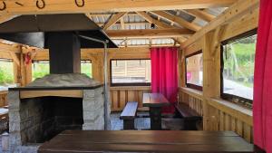 an inside view of a cabin with a fireplace at Osada Modrzewiowe Wzgórze Bieszczady in Ustrzyki Dolne