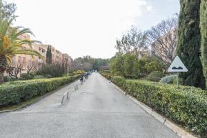 an empty street in a city with a bike lane at Appartement Les Elfes in Le Pradet