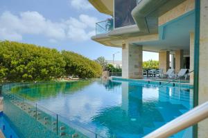 a swimming pool in the middle of a house at 2 BR Oceanview Condo Coral Shell 3e in Oranjestad