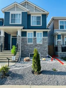 a house with a gravel yard in front of it at Chic City Escape- come experience tranquility! in Calgary