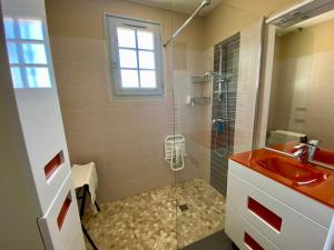 a bathroom with a red sink and a shower at La Rousselie in Montagrier +20 photos