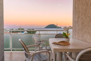 a table and chairs on a balcony with a view of the ocean at Residence Riviera in Albenga