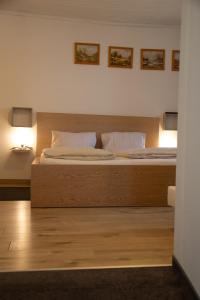 a bedroom with a large bed with two pillows at Bockwirt in Schladming