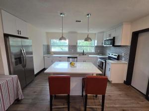 a kitchen with a table and two chairs in it at 2Bed 2Bath Lake Front Jewel in Lake Mary