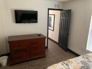 a bedroom with a dresser and a flat screen tv at 2Bed 2Bath Lake Front Jewel in Lake Mary
