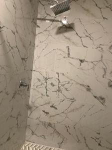a bathroom with a marble shower with a glass door at 2Bed 2Bath Lake Front Jewel in Lake Mary +8 photos