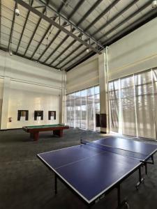 a ping pong table in a large room with a ping pong table at SMDC Wind Residences Condo Unit by Bil & J's in Kaybagal