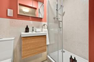 a bathroom with a shower and a sink and a toilet at GuestReady - The Bridge - Wealdstone in London
