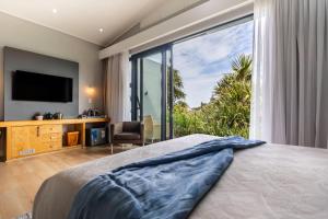 a bedroom with a bed and a large window at Isango Gate in Port Elizabeth