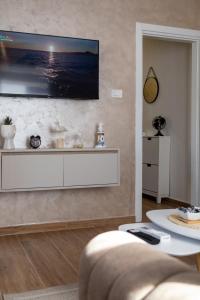 a living room with a tv on a wall at Lighthouse Kotor in Prčanj
