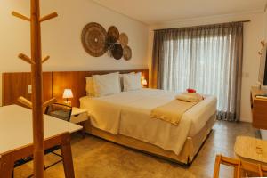 a hotel room with two beds and a cross on the wall at Pousada Moana in Fernando de Noronha +81 photos