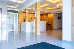 a lobby with white pillars in a building at Holiday Home Resort & Spa in Jarosławiec +63 photos