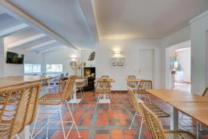 a dining room with wooden tables and chairs at Les Rizières in Saintes-Maries-de-la-Mer