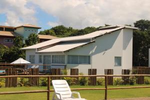 a white chair sitting in front of a house at vila sua casa 2 in Santo André