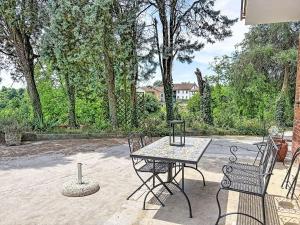 a table and chairs sitting on a patio at Apartment Cà Maria-2 by Interhome in Asti