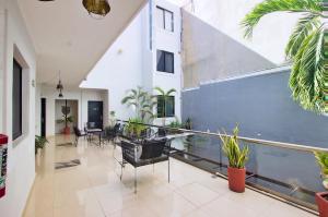 a large hallway with plants and chairs in a building at Aruma Suites in Playa del Carmen