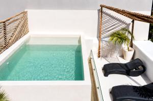a swimming pool on the balcony of a house at Aruma Suites in Playa del Carmen