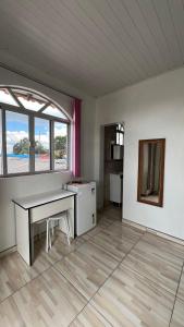 an empty room with a desk and a window at Pousada Bela Vista in Castro