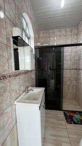 a bathroom with a sink and a mirror at Pousada Bela Vista in Castro +20 photos