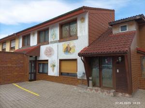a large brick building with a parking lot in front of it at Gästehaus Gartenstraße 5 vom Central Hotel in Schwetzingen