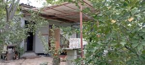 an old house with a pergola in front of it at погружение в природу in Drăsliceni