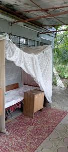 a bed in a tent with a mosquito net at погружение в природу in Drăsliceni