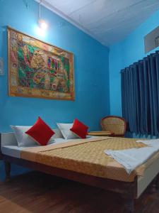 a bedroom with a large bed with red pillows at Mayur Guest House in Pushkar +50 photos