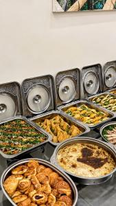 a bunch of trays filled with different types of food at Maea wade ram in Disah